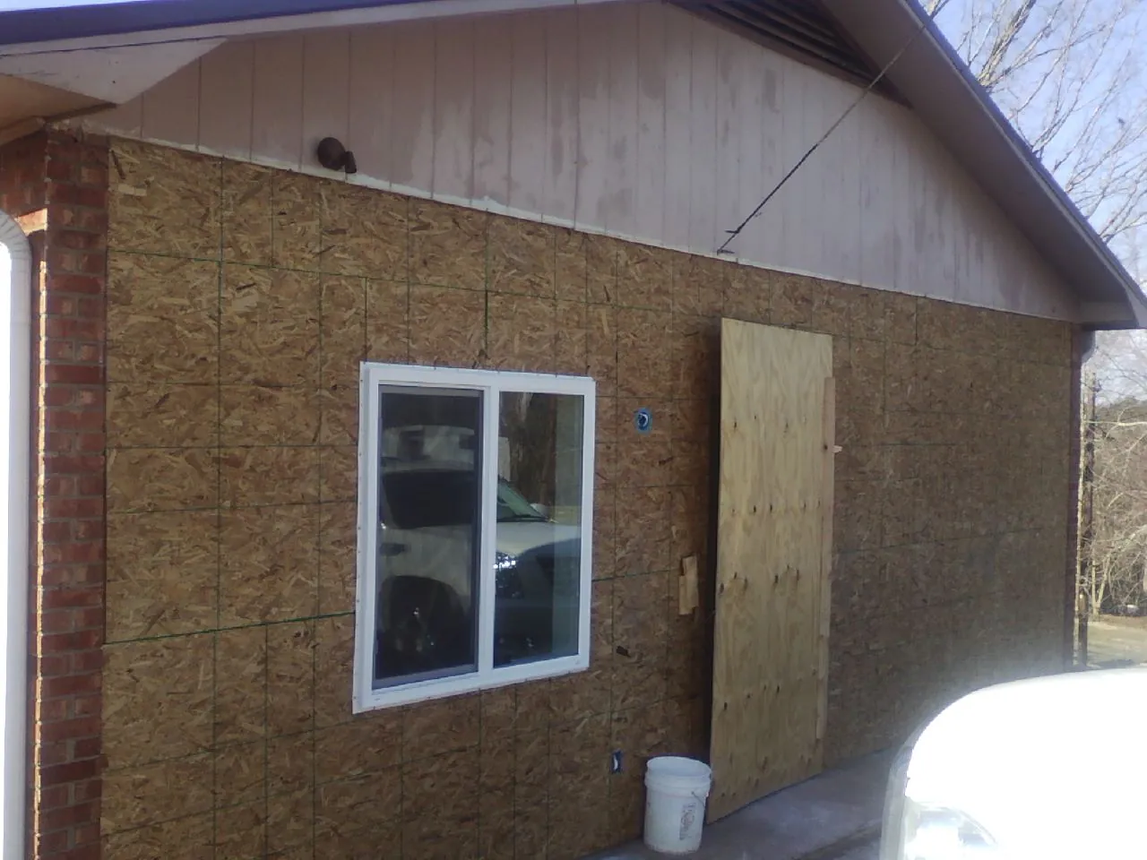 OSB sheathing on a garage addition wall before siding in Matheson